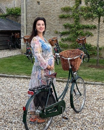 Picture of Matilda Sturridge, ready to ride a cycle in her beautiful white dress